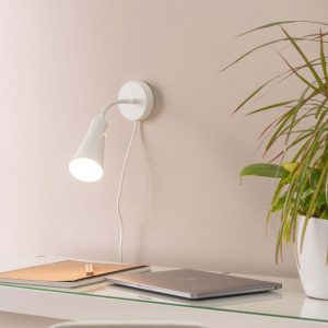 Goose neck plug in wall light bedside reading lamp in white shown above office desk