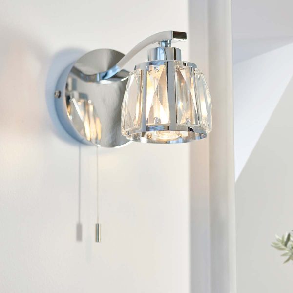Ria single switched bathroom wall light in polished chrome fitted to wall lit
