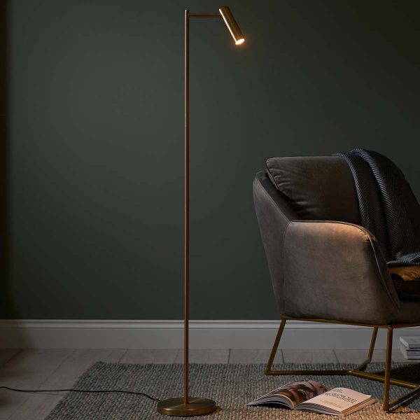 Modern LED dedicated floor reading lamp in warm brass in sitting room setting