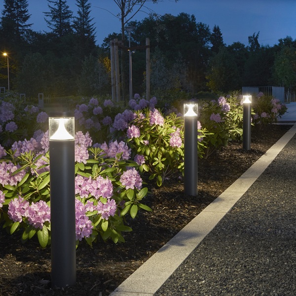 Set of bollards illuminating driveway edge at night