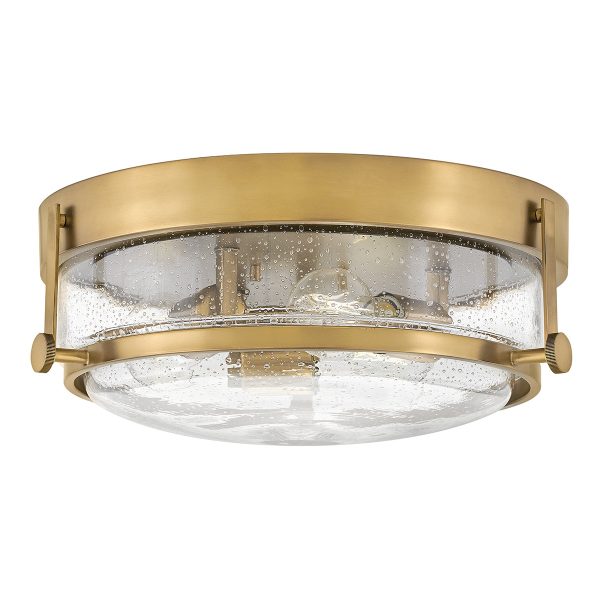 Hinkley Harper 3 lamp flush light in heritage brass with clear seeded glass on white background