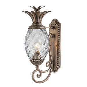 Plantation 1 light medium outdoor wall lantern in burnished bronze on white background, lit