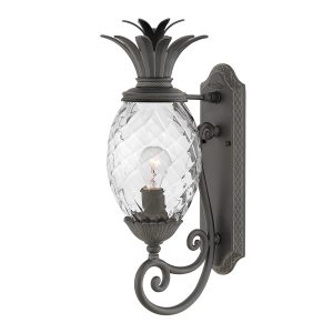 Plantation 1 light medium outdoor wall lantern in museum black on white background, lit