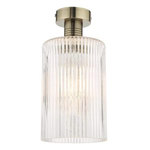 Emerson low ceiling light in aged brass with ribbed cylinder glass shade on white background
