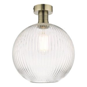 Emerson low ceiling light in antique brass with ribbed glass globe shade on white background