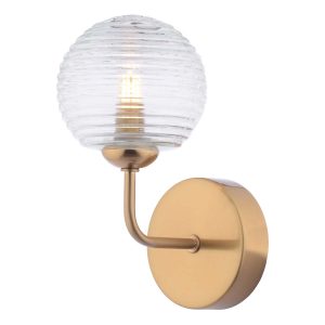 Feya single wall light in antique bronze with ribbed glass shade on white background lit