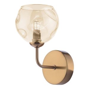 Feya single wall light in antique bronze with champagne glass shade on white background lit