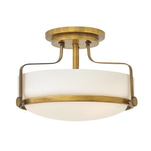 Hinkley Harper small semi flush light in heritage brass finish with opal glass on white background