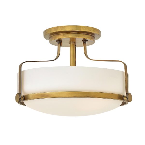 Hinkley Harper small semi flush light in heritage brass finish with opal glass on white background