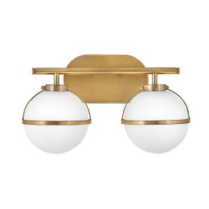 Hinkley Hollis 2 light bathroom wall light in heritage brass with opal glass shades on white background.