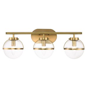 Hinkley Hollis 3 light over bathroom mirror light in heritage brass with seeded glass on white background, lit.