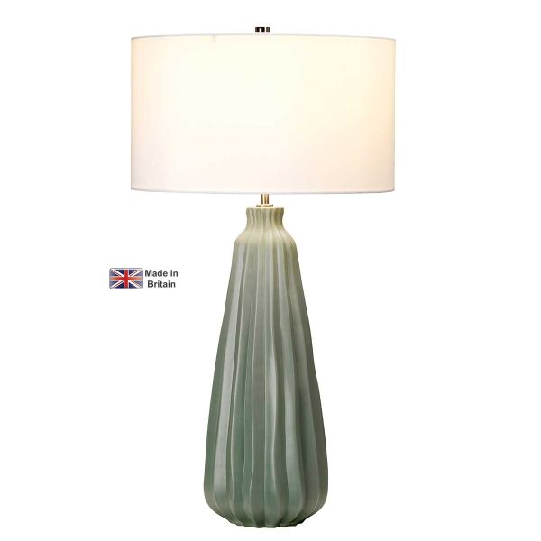 Elstead Kew large green ceramic table lamp with white shade on white background, lit.