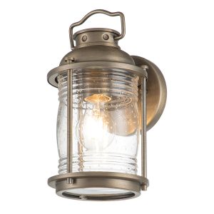 Kichler Ashland Bay 1 light small outdoor wall lantern in burnished bronze on white background, lit.