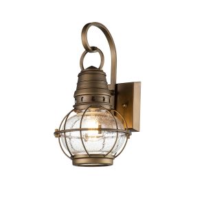 Kichler Bridge Point 1 light small outdoor wall lantern in natural brass finish on white background, lit.