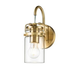 Kichler Brinley single wall light in brushed brass on white background, lit.