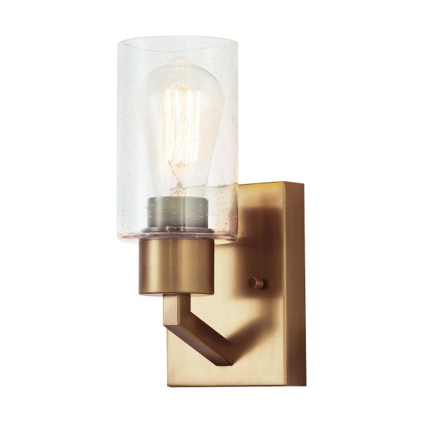 Kichler Deryn single wall light in distressed natural brass finish, on white background, lit.