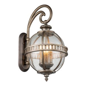 Kichler Halleron 3 light medium outdoor wall lantern in burnished bronze finish on white background, lit.