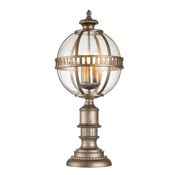 Kichler Halleron 3 light outdoor pedestal lantern in burnished bronze finish on white background, lit.