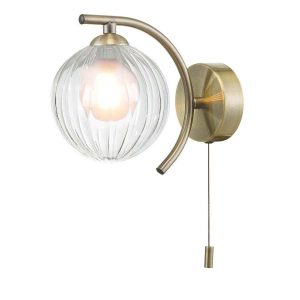 Nakita switched wall light in antique brass with clear ribbed glass outer and opal glass inner shade on white background