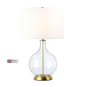 Elstead Orb clear glass table lamp in antique brass with white shade on white background, lit.