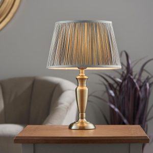 Oslo small traditional table lamp in antique brass grey silk shade roomset