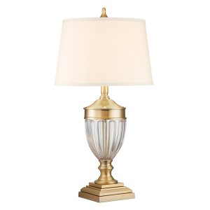 Quoizel Dennison 1 light brushed brass table lamp on white background, lit