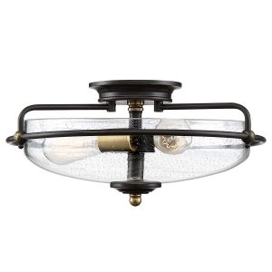 Quoizel Griffin 3 light flush ceiling light in Palladian bronze with weathered brass accents and seeded glass on white background