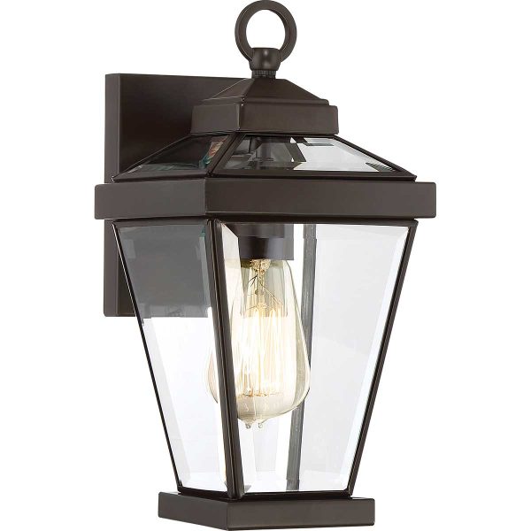 Quoizel Ravine small classic outdoor wall lantern in western bronze on white background, lit