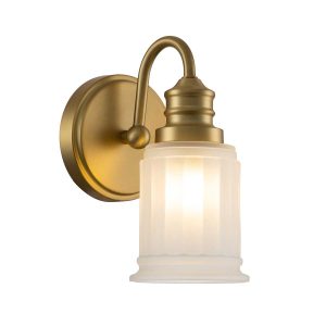 Quoizel Swell single bathroom wall light in brushed brass on white background lit