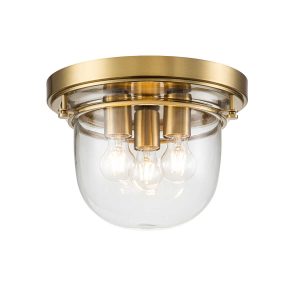 Quoizel Whistling 3 light flush bathroom ceiling light in brushed brass on white background, lit