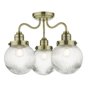 Tamara 3 arm bathroom semi flush light in antique brass with ribbed glass shades on white background lit